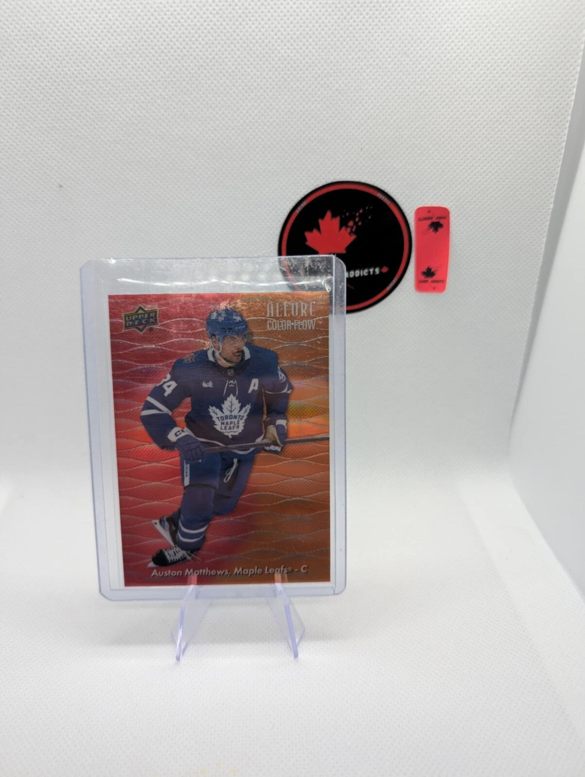 2023-24 AUSTON MATTHEWS UPPER DECK ALLURE COLOR FLOW RED-ORANGE